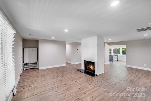 2000 Tyvola Rd, Charlotte, NC 28210 - unfurnished living room with a fireplace, light wood-type flooring, and recessed lighting