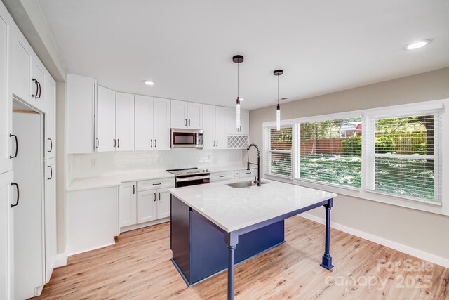 2000 Tyvola Rd, Charlotte, NC 28210 - kitchen with stainless steel appliances, backsplash, a breakfast bar, light wood finished floors, and recessed lighting