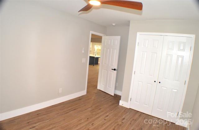 2000 Tyvola Rd, Charlotte, NC 28210 - unfurnished bedroom with light wood-type flooring, a closet, and a ceiling fan