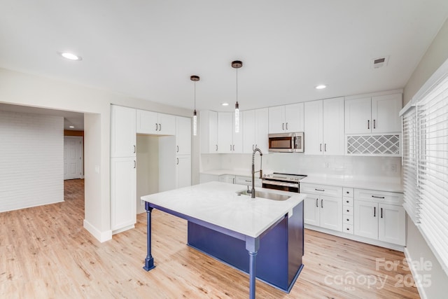 2000 Tyvola Rd, Charlotte, NC 28210 - kitchen with appliances with stainless steel finishes, white cabinetry, light wood-style floors, light countertops, and backsplash