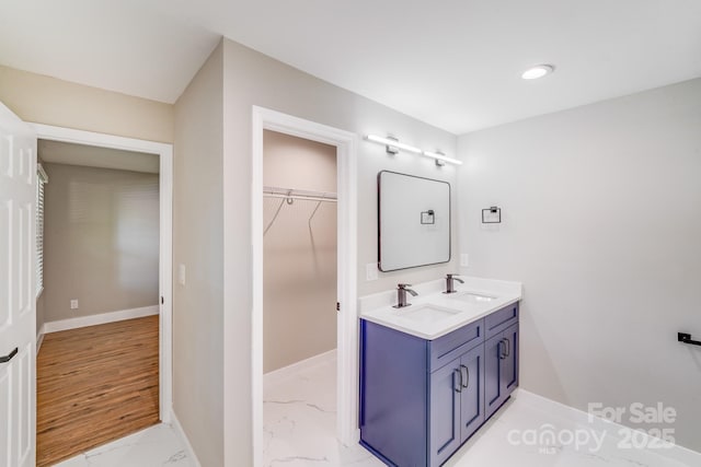 2000 Tyvola Rd, Charlotte, NC 28210 - full bathroom with double vanity, marble look tiles, a walk in closet, and recessed lighting