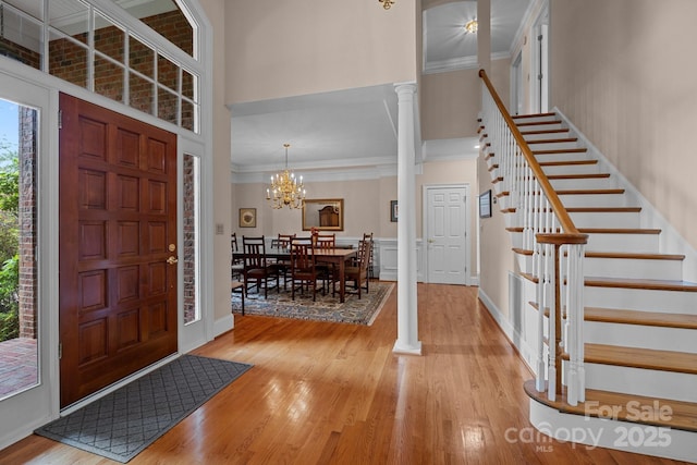 10317 Clubhouse View Ln, Mint Hill, NC 28227 - entrance foyer featuring wood finished floors, a high ceiling, crown molding, stairway, and a chandelier