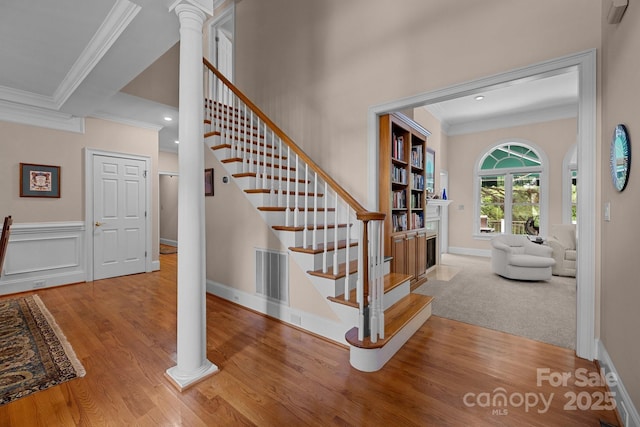10317 Clubhouse View Ln, Mint Hill, NC 28227 - stairs with crown molding, wood finished floors, ornate columns, a fireplace, and recessed lighting