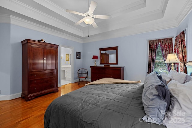 10317 Clubhouse View Ln, Mint Hill, NC 28227 - bedroom featuring a tray ceiling, light wood-style flooring, crown molding, a ceiling fan, and ensuite bathroom