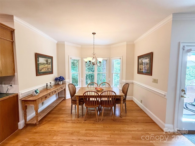 10317 Clubhouse View Ln, Mint Hill, NC 28227 - dining space featuring light wood-style flooring, a chandelier, plenty of natural light, and ornamental molding