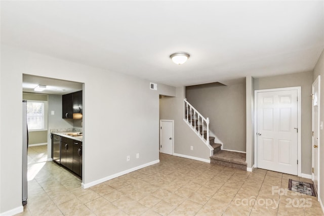 9464 Lexington Cir Unit B, Charlotte, NC 28213 - unfurnished room with stairway, a sink, and baseboards