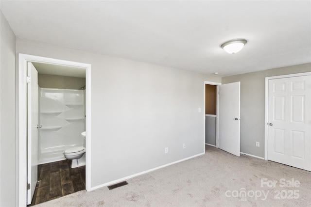 9464 Lexington Cir Unit B, Charlotte, NC 28213 - unfurnished bedroom featuring baseboards, ensuite bath, and carpet
