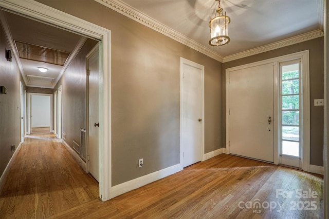 1503 Brentwood Dr, Newton, NC 28658 - foyer featuring wood finished floors, ornamental molding, baseboards, and a chandelier