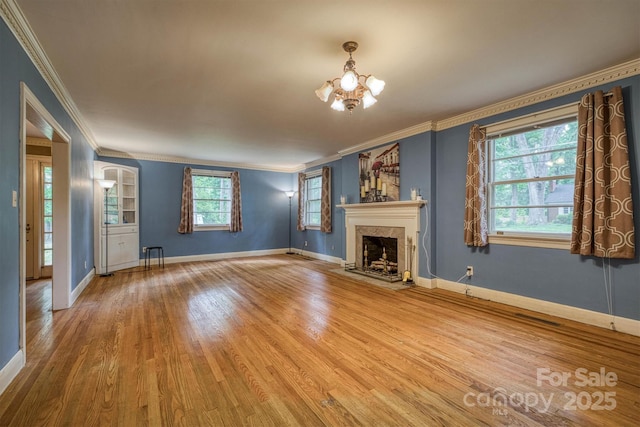 1503 Brentwood Dr, Newton, NC 28658 - unfurnished living room with crown molding, a chandelier, wood finished floors, a high end fireplace, and baseboards
