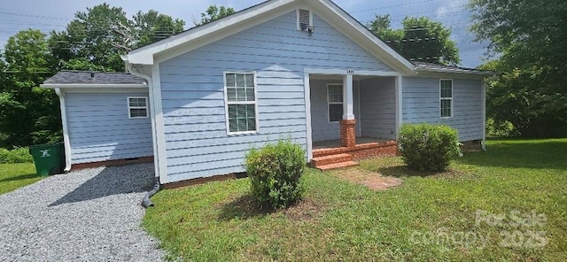 bungalow-style home with a front yard