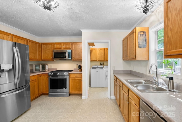 370 Fox Cove Rd, Mars Hill, NC 28754 - kitchen featuring appliances with stainless steel finishes, washer and dryer, a sink, brown cabinets, and light countertops