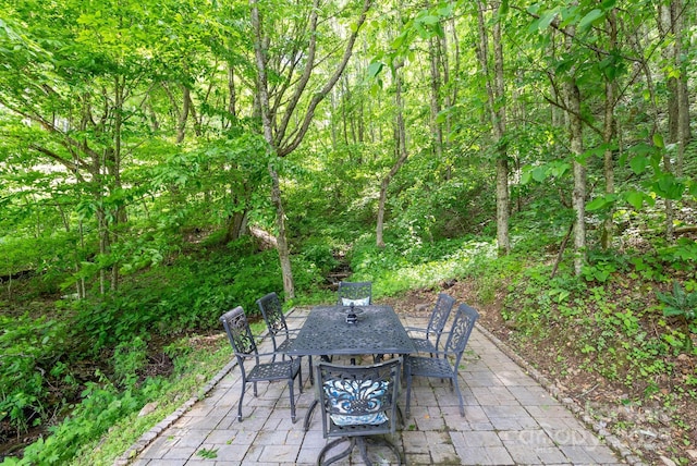 370 Fox Cove Rd, Mars Hill, NC 28754 - view of patio / terrace featuring outdoor dining area and a wooded view