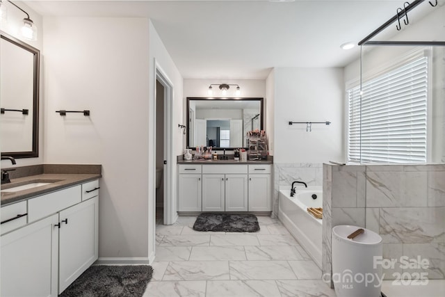 5121 Ennisworth Ln, Charlotte, NC 28214 - full bathroom featuring marble finish floors, a garden tub, and two vanities