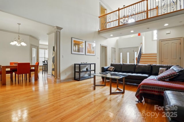 1705 Townsend Ln, Rock Hill, SC 29730 - living room with light wood-style flooring, a chandelier, a towering ceiling, stairway, and baseboards