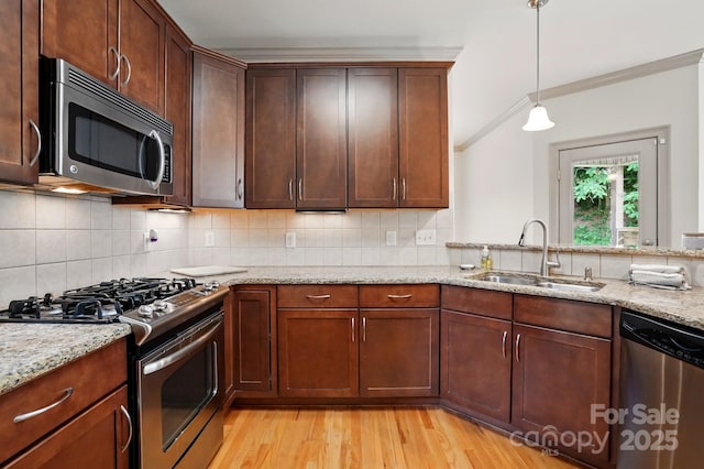 1705 Townsend Ln, Rock Hill, SC 29730 - kitchen featuring stainless steel appliances, a sink, ornamental molding, light wood finished floors, and light stone countertops