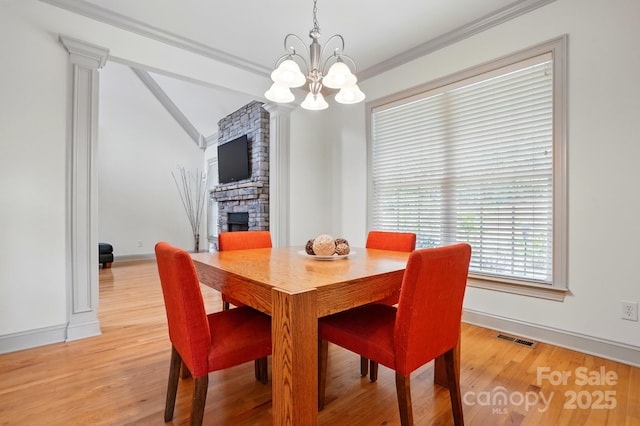 1705 Townsend Ln, Rock Hill, SC 29730 - dining room with a stone fireplace, a chandelier, light wood finished floors, baseboards, and lofted ceiling
