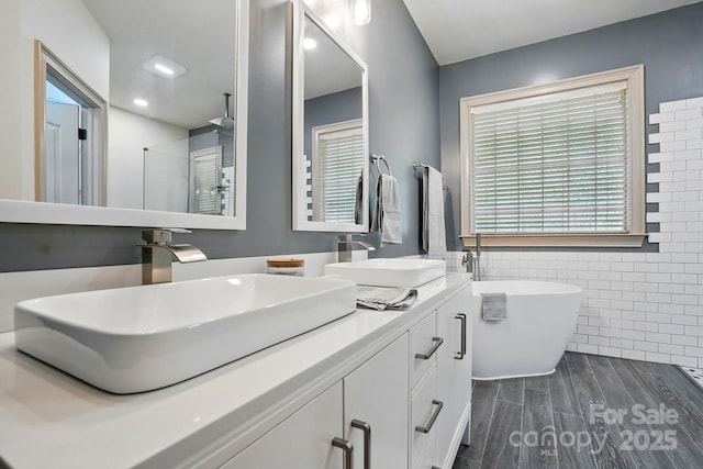 1705 Townsend Ln, Rock Hill, SC 29730 - full bath featuring tile walls, double vanity, wood finished floors, a freestanding bath, and a walk in shower