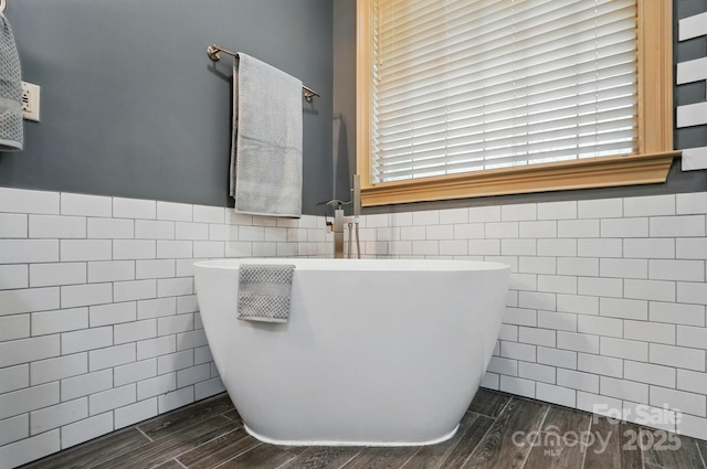 1705 Townsend Ln, Rock Hill, SC 29730 - bathroom featuring tile walls, a freestanding bath, wood finished floors, and wainscoting