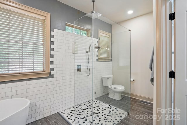 1705 Townsend Ln, Rock Hill, SC 29730 - full bath featuring a shower stall, tile walls, a freestanding bath, toilet, and wood finished floors