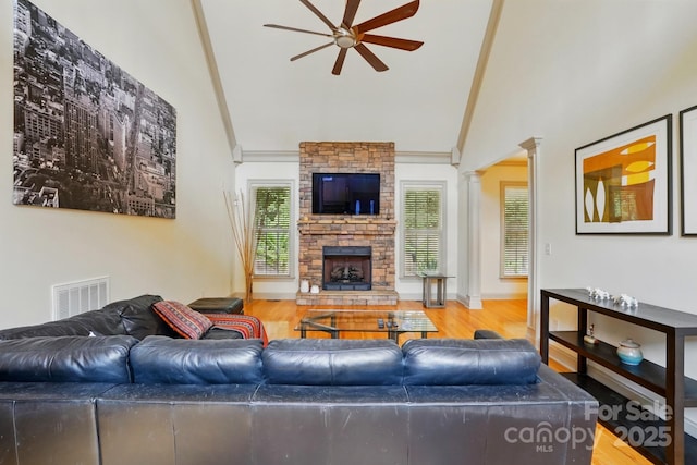 1705 Townsend Ln, Rock Hill, SC 29730 - living area featuring ceiling fan, a stone fireplace, high vaulted ceiling, wood finished floors, and decorative columns