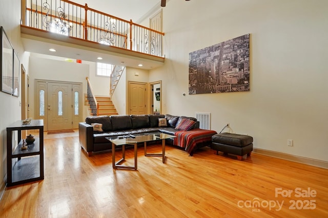 1705 Townsend Ln, Rock Hill, SC 29730 - living room with a towering ceiling, wood finished floors, stairs, and baseboards