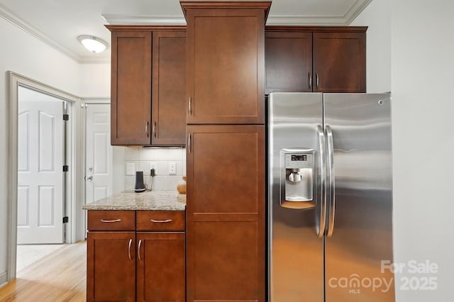 1705 Townsend Ln, Rock Hill, SC 29730 - kitchen with stainless steel fridge with ice dispenser, crown molding, light stone countertops, and light wood-style floors