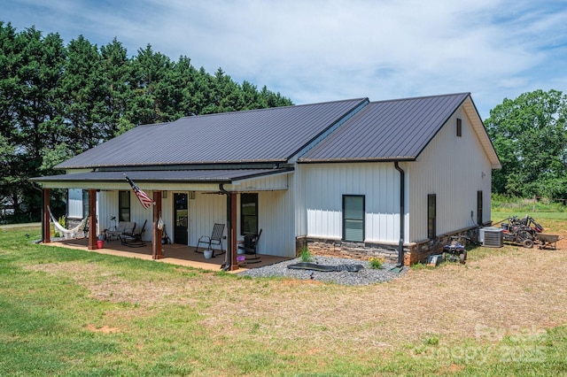 1138 Zeb Haynes Rd, Maiden, NC 28650 - view of front facade with a front yard, cooling unit, a patio area, and metal roof