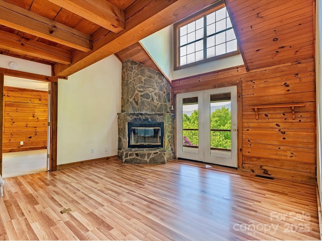 287 Sara Ridge Rd, Waynesville, NC 28786 - unfurnished living room with a fireplace, wood finished floors, wood walls, wooden ceiling with exposed beams, and baseboards