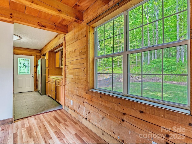 287 Sara Ridge Rd, Waynesville, NC 28786 - doorway to outside featuring wooden walls, beam ceiling, and light wood-style flooring