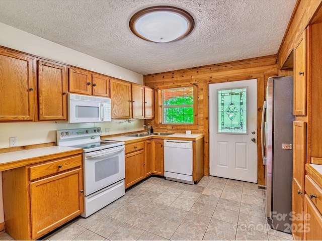 287 Sara Ridge Rd, Waynesville, NC 28786 - kitchen featuring white appliances, a sink, a textured ceiling, light countertops, and brown cabinets