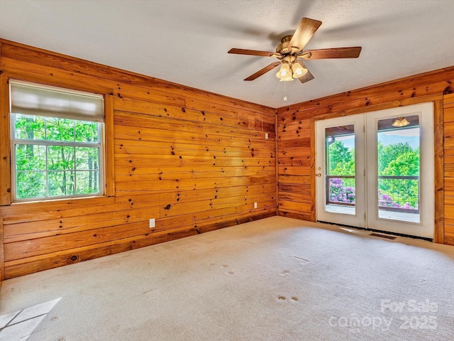 287 Sara Ridge Rd, Waynesville, NC 28786 - carpeted empty room featuring ceiling fan and wood walls