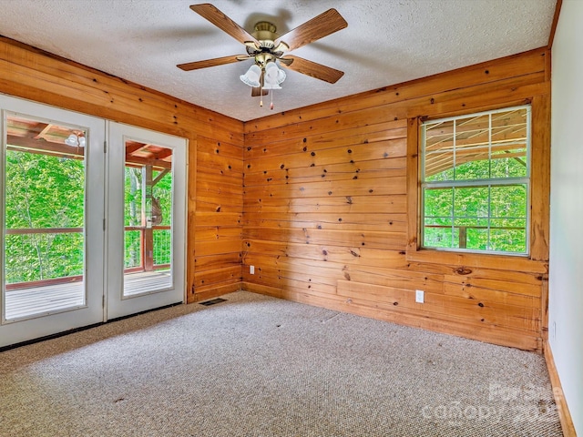 287 Sara Ridge Rd, Waynesville, NC 28786 - empty room with carpet, wood walls, a textured ceiling, and a ceiling fan