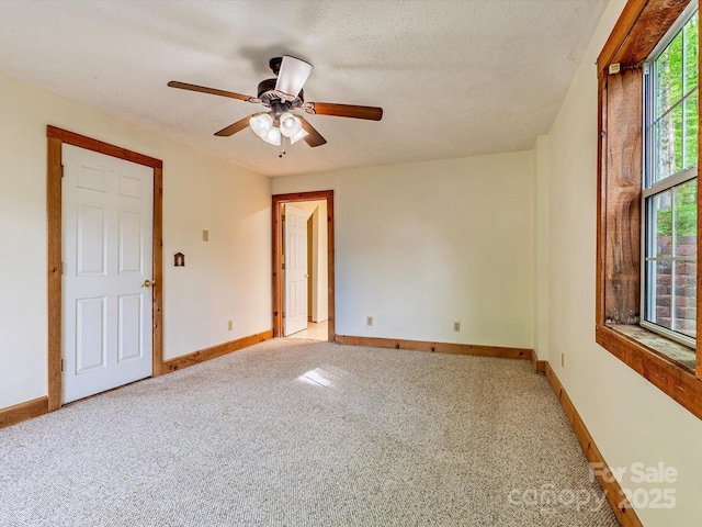 287 Sara Ridge Rd, Waynesville, NC 28786 - spare room with light carpet, baseboards, a ceiling fan, and a textured ceiling
