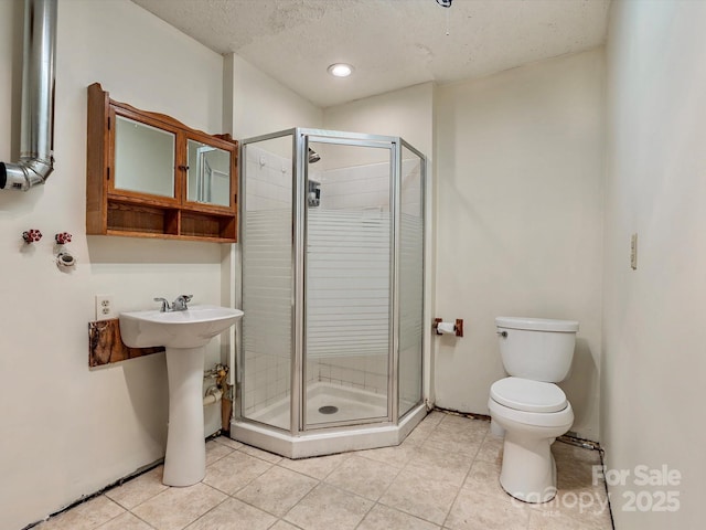 287 Sara Ridge Rd, Waynesville, NC 28786 - bathroom with toilet, a shower stall, tile patterned floors, a textured ceiling, and recessed lighting