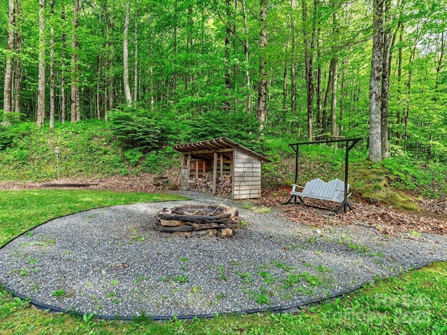287 Sara Ridge Rd, Waynesville, NC 28786 - view of yard featuring an outdoor fire pit, an outbuilding, and a forest view