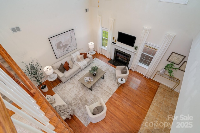 2504 Korbel Ct, Waxhaw, NC 28173 - living area with wood finished floors, a high ceiling, and a fireplace with flush hearth