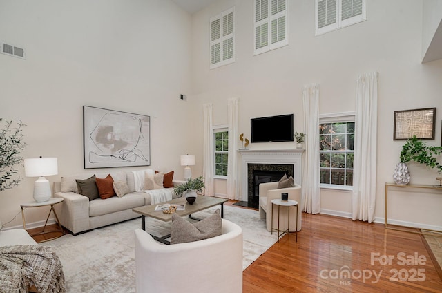 2504 Korbel Ct, Waxhaw, NC 28173 - living area featuring a high ceiling, light wood-style flooring, and a high end fireplace
