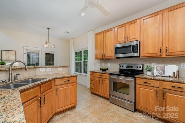 2504 Korbel Ct, Waxhaw, NC 28173 - kitchen featuring appliances with stainless steel finishes, light stone counters, decorative backsplash, ceiling fan, and pendant lighting