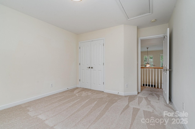 2504 Korbel Ct, Waxhaw, NC 28173 - unfurnished bedroom with attic access, light carpet, and a closet