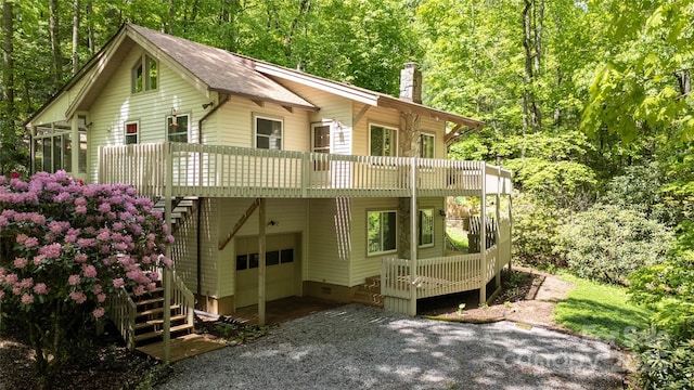 1 Spring Rd, Spruce Pine, NC 28777 - view of front of property with a garage, stairs, a chimney, gravel driveway, and a wooded view