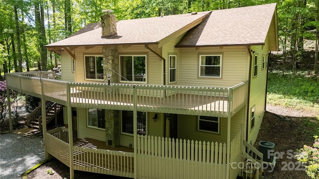 1 Spring Rd, Spruce Pine, NC 28777 - chalet / cabin featuring a wooden deck, stairs, a shingled roof, and a chimney