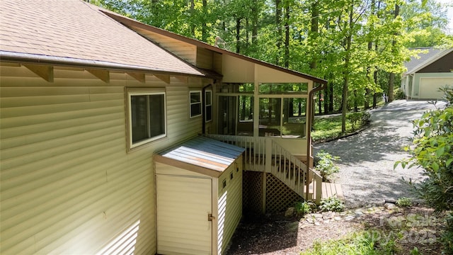1 Spring Rd, Spruce Pine, NC 28777 - view of side of home featuring roof with shingles, a sunroom, and stairway