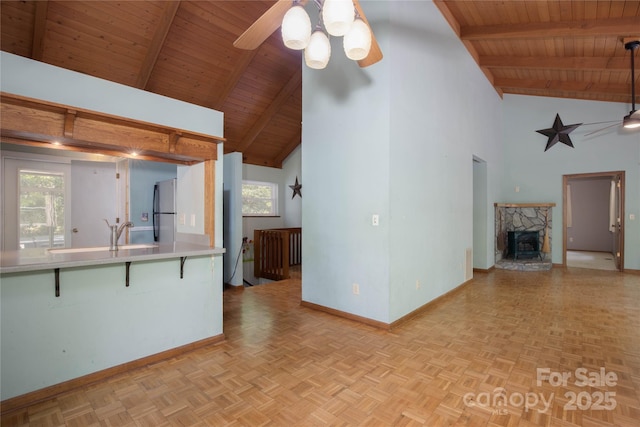 1 Spring Rd, Spruce Pine, NC 28777 - unfurnished living room with wood ceiling, a ceiling fan, baseboards, high vaulted ceiling, and beam ceiling