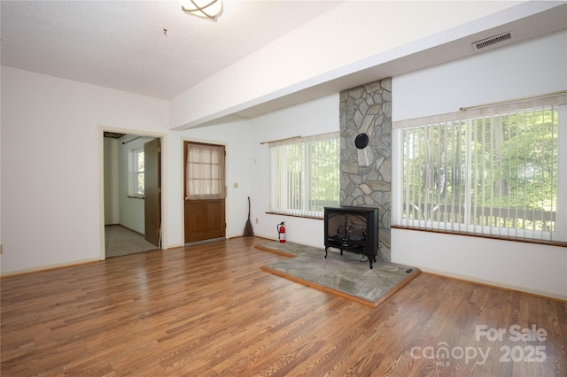 1 Spring Rd, Spruce Pine, NC 28777 - unfurnished living room featuring wood finished floors and a wood stove