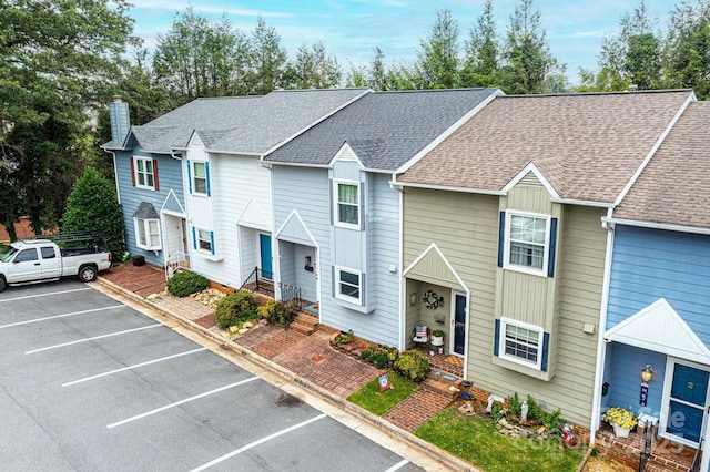 617 College Ave SW, Lenoir, NC 28645 - view of property with uncovered parking, a shingled roof, and a chimney