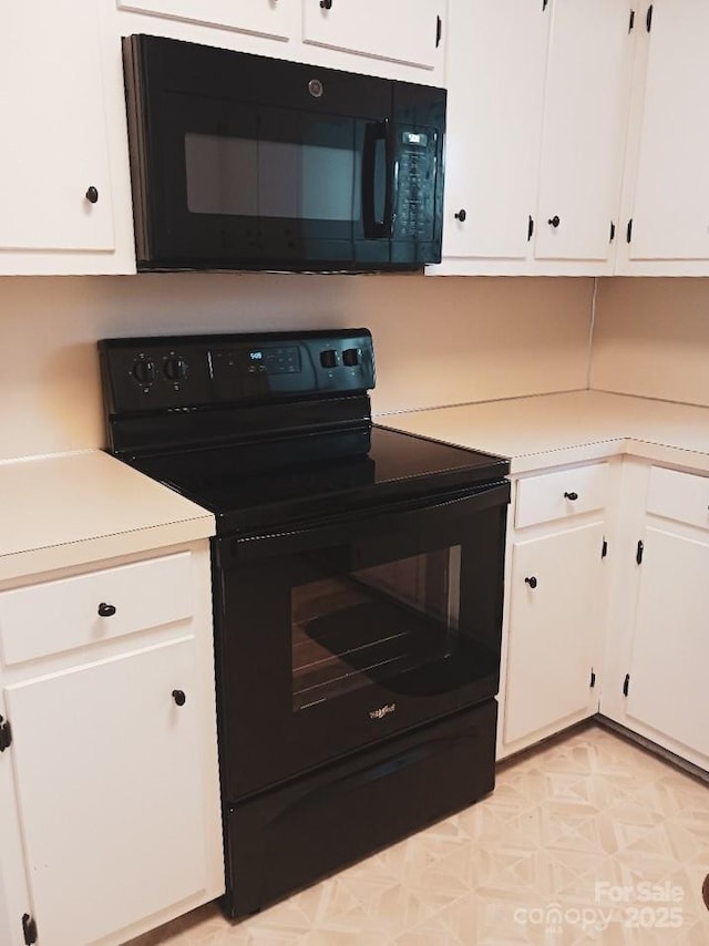 617 College Ave SW, Lenoir, NC 28645 - kitchen featuring black appliances, light countertops, and white cabinets