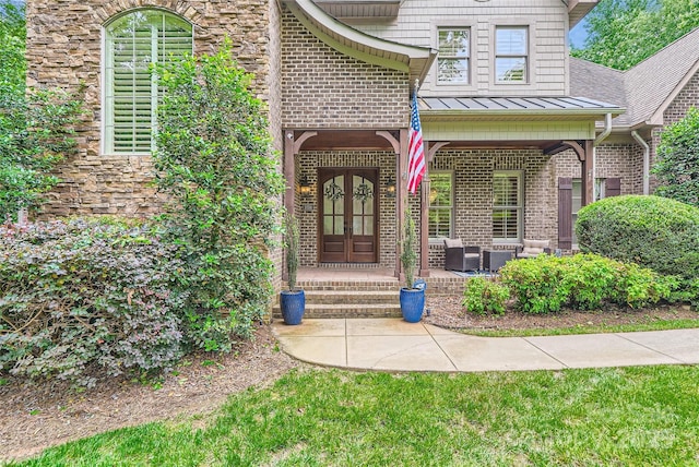1056 James Madison Dr, Matthews, NC 28104 - doorway to property with a standing seam roof, brick siding, french doors, metal roof, and an outdoor hangout area
