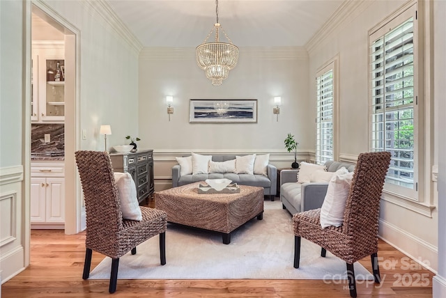 1056 James Madison Dr, Matthews, NC 28104 - living area featuring a chandelier, light wood finished floors, and ornamental molding