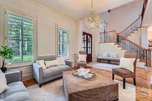 1056 James Madison Dr, Matthews, NC 28104 - living area with a chandelier, stairway, light wood-type flooring, crown molding, and french doors
