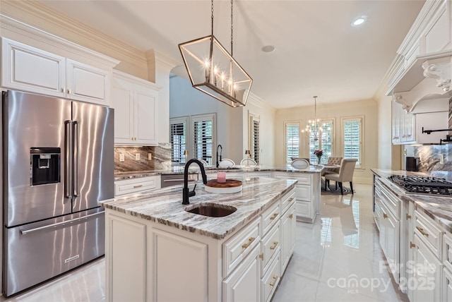 1056 James Madison Dr, Matthews, NC 28104 - kitchen with appliances with stainless steel finishes, a chandelier, a sink, backsplash, and white cabinetry
